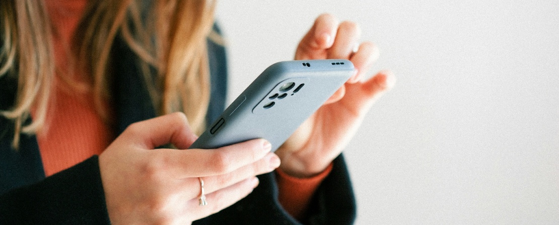 Photographie d'une femme tenant un téléphone portable